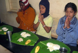 Inmates praying before Lunch